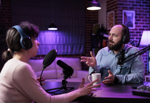 Man and woman creating podcast content online with equipment, recording social media discussion. Team of influencers talking about lifestyle and internet channel on live broadcast.